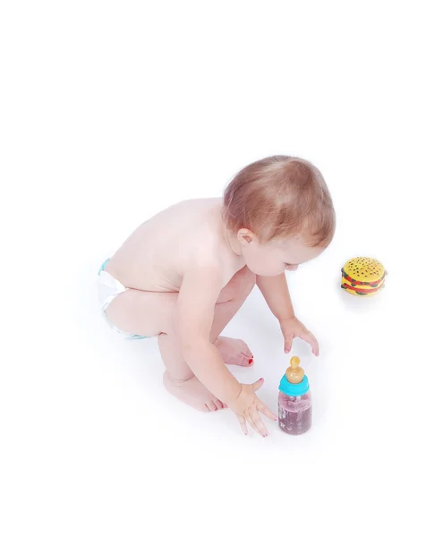 Baby between hamburger and drinking bottle — Stock Photo, Image