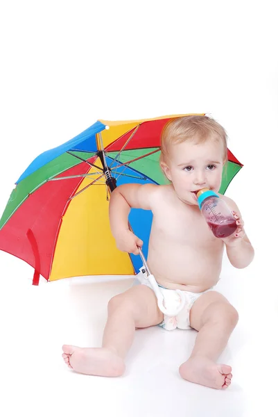 Baby in white with umbrella — Stock Photo, Image