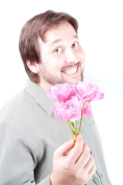 Cute man offering pink roses — Stock Photo, Image