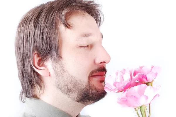 Cute man offering pink roses — Stock Photo, Image
