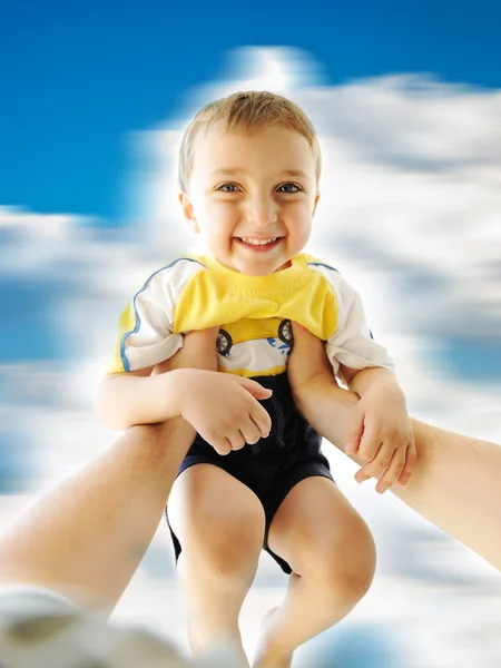 Very happy little cute boy up in his father's arms, rotating together: — Stock Photo, Image
