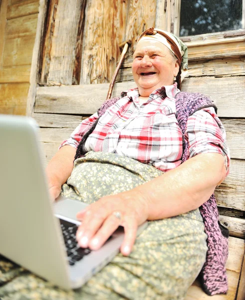 Senior aged woman with laptop — Stock Photo, Image