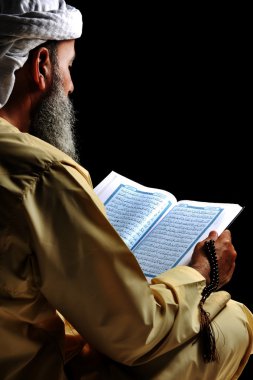 Muslim reading Koran clipart