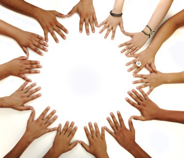 Conceptual symbol of multiracial children hands making a circle on white b