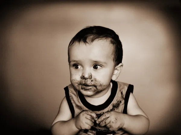 Cute messy baby, low key light, added grain for film effect — Stock Photo, Image