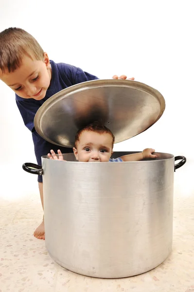 Cute child in pot, playing together, brothers — Stock Photo, Image