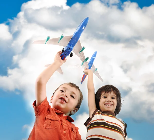 stock image Two small boys with airplains in hands, idea for traveling around the World