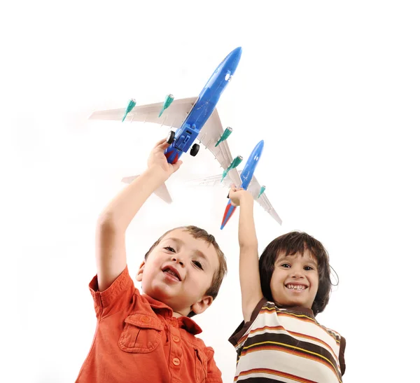 stock image Two small boys with airplains in hands, idea for traveling around the World