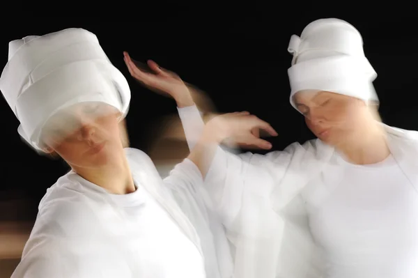 Artistic motion photo of white sufy female dancers — Stock Photo, Image