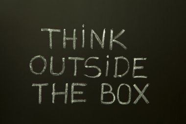 THINK OUTSIDE THE BOX on a blackboard clipart
