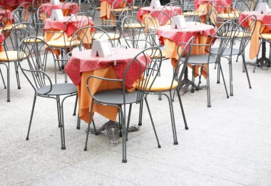 Metal chairs and tables in an outdoor bar clipart