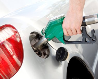 A man pumping gas in to the tank clipart