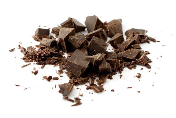Pedaços de chocolate no fundo branco macro — Fotografia de Stock