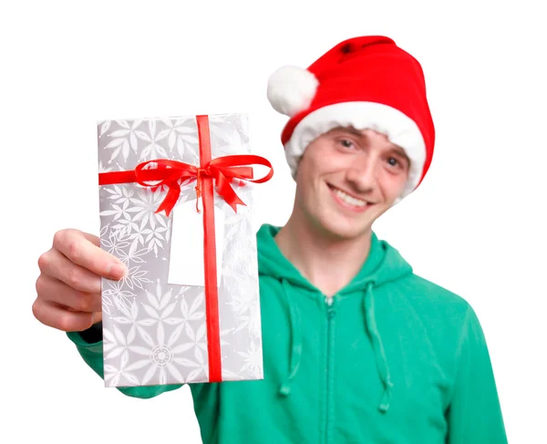 Noel hediyesi holding Noel Baba şapkası olan adam — Stok fotoğraf