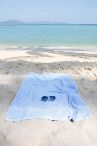 Sunglasses and towel — Stock Photo, Image