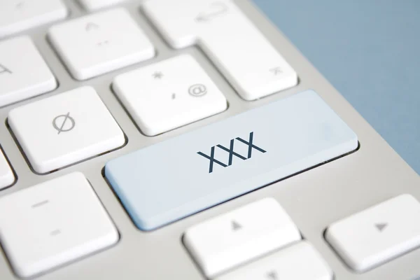 Um botão com xxx nele — Fotografia de Stock