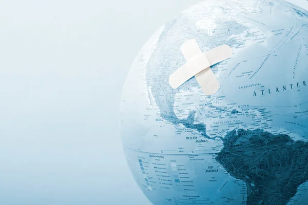 Globe with bandage — Stock Photo, Image