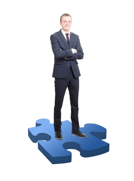 Businessman on puzzle piece — Stock Photo, Image