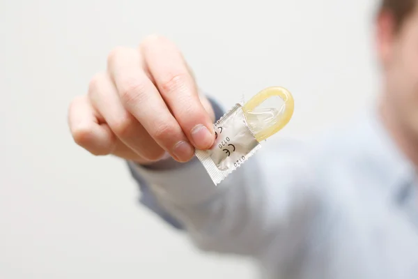Man holding condom — Stock Photo, Image