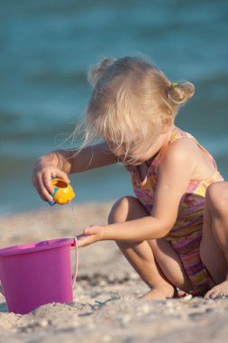 Little girl joys on a beach clipart