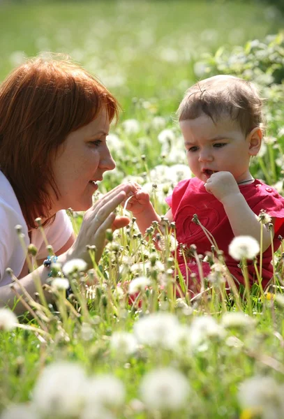 Moeder met dochter liggend op een gras — Stockfoto