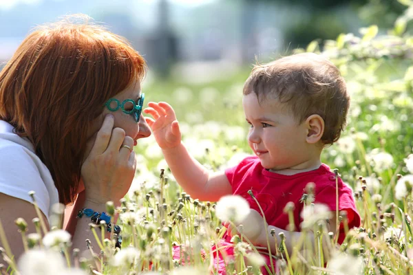 Mother with daughter lying on a grass — Stock Photo, Image