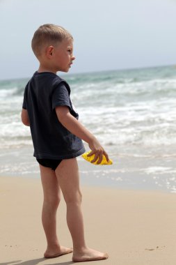 Little boy on the beach clipart