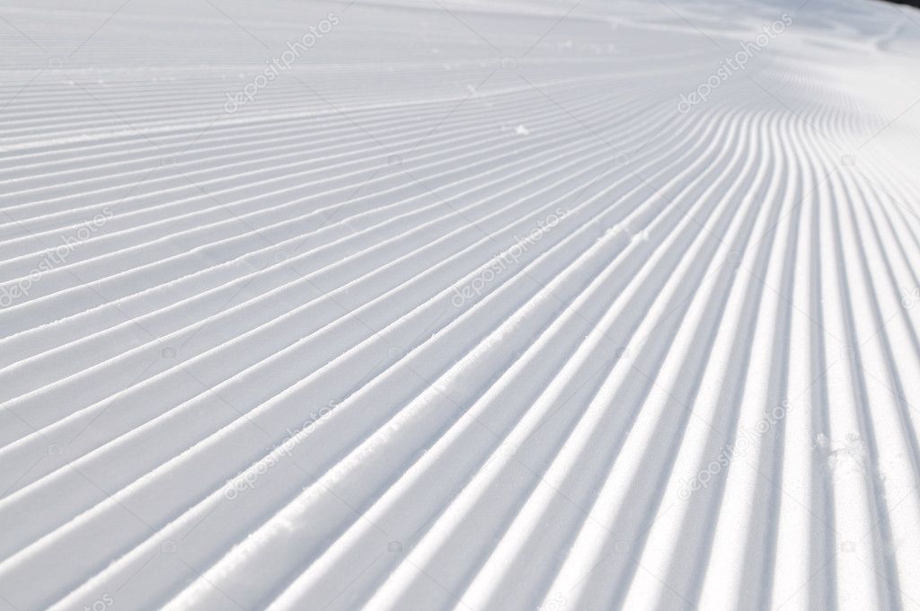 Tracks on ski slopes at beautiful sunny winter day