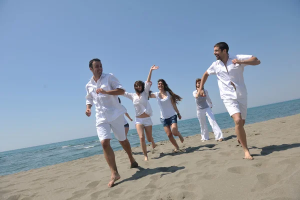 Grupo feliz divertirse y correr en la playa — Foto de Stock