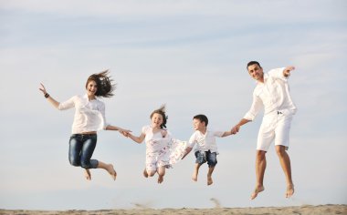 Happy young family have fun on beach clipart