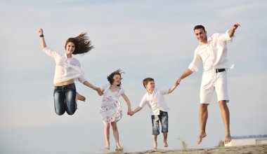 Mutlu genç aile sahilde eğleniyor.