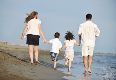 Mutlu genç aile sahilde eğleniyor.