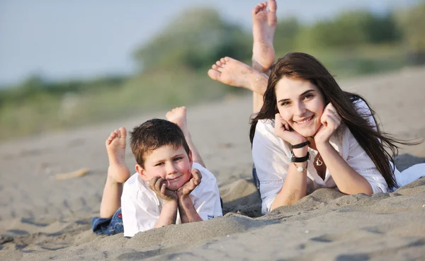 Mom and son relaxing on beach — Stock Photo, Image
