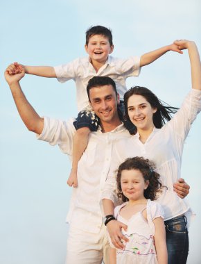 Happy young family have fun on beach clipart