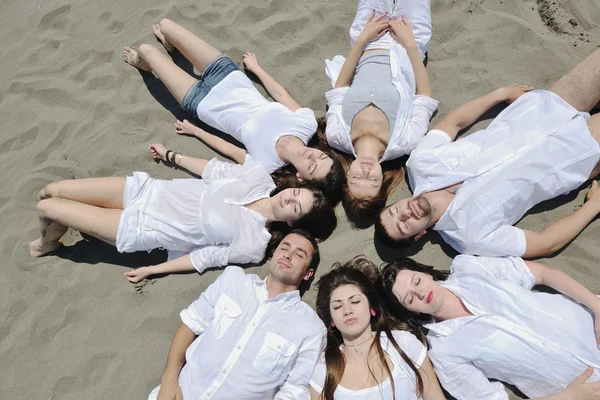 Grupo de jovens felizes em se divertir na praia — Fotografia de Stock