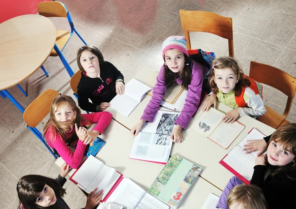 Niños felices con profesor en el aula de la escuela —  Fotos de Stock