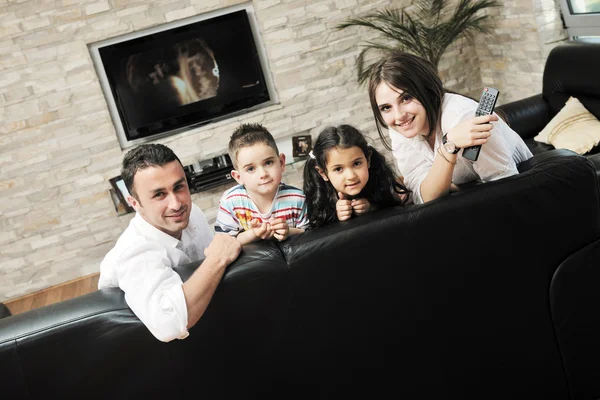 Glad ung familj ha kul och arbetar på laptop hemma — Stockfoto