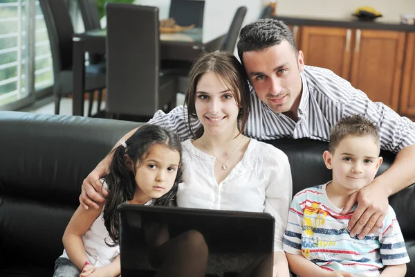 Happy young family have fun and working on laptop at home — Stock Photo, Image