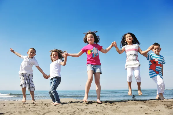 Happy child group playing on beach Royalty Free Stock Images