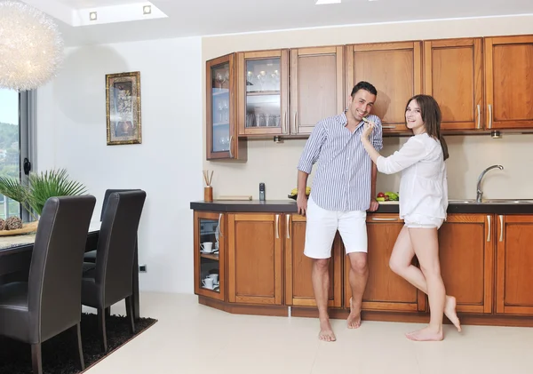 Happy young couple have fun in modern kitchen — Stock Photo, Image