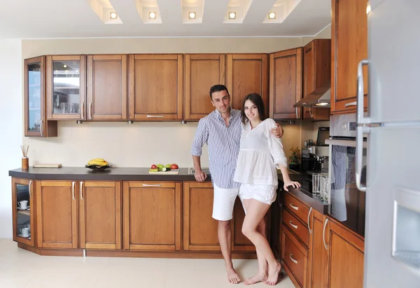 stock image Happy young couple have fun in modern kitchen