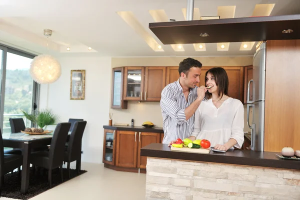 Happy young couple have fun in modern kitchen Stock Picture