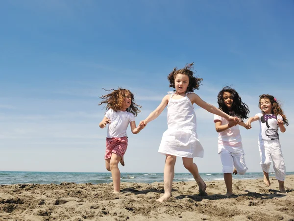 Happy child group playing on beach Royalty Free Stock Images