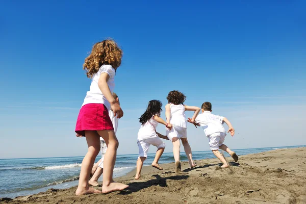 Happy child group playing on beach — Stock Photo, Image