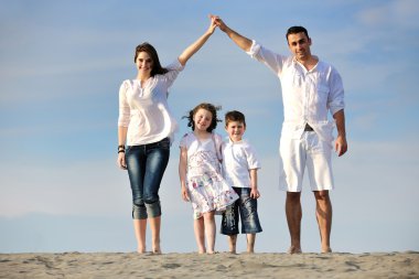 Family on beach showing home sign clipart