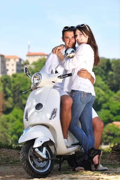 Portrait of happy young love couple on scooter enjoying summer t — Stock Photo, Image