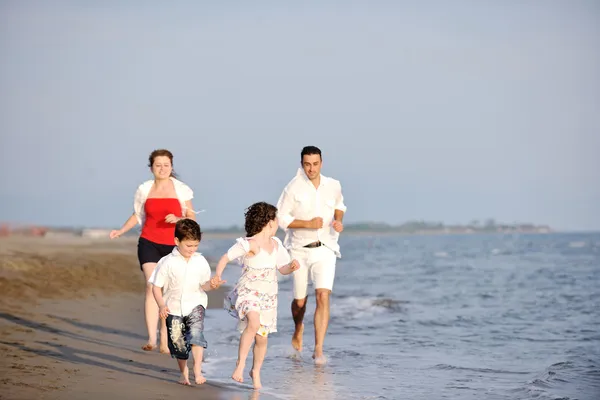 Happy young family have fun on beach — Stock Photo, Image
