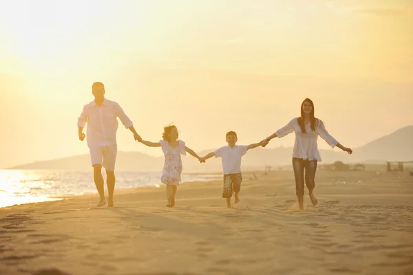 Happy young family have fun on beach — Stock Photo, Image