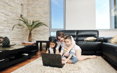 Family wathching flat tv at modern home indoor clipart