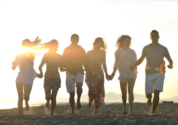 Gelukkig jonge groep hebben plezier op strand — Stockfoto